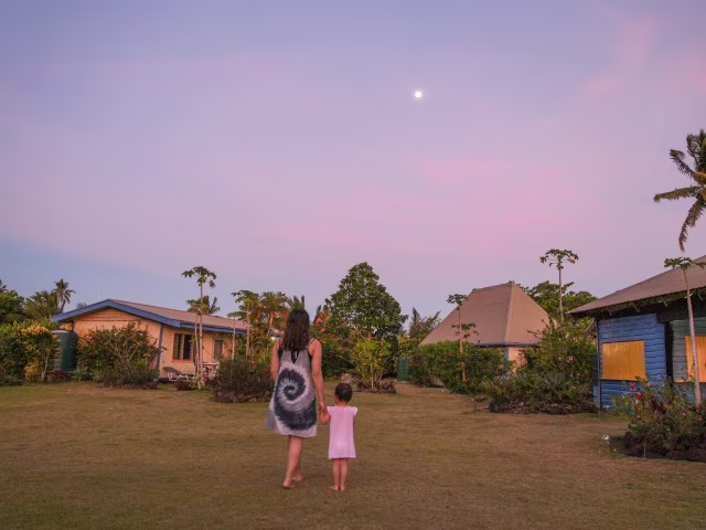 mother daughter walking towards sunset on Fiji island