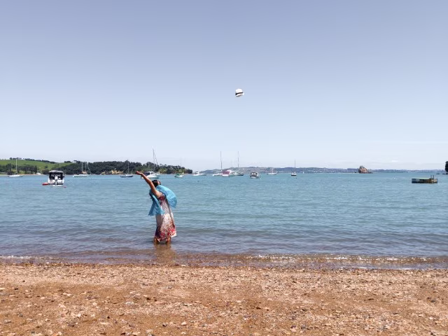 girl throwing a hat on a beach in sea