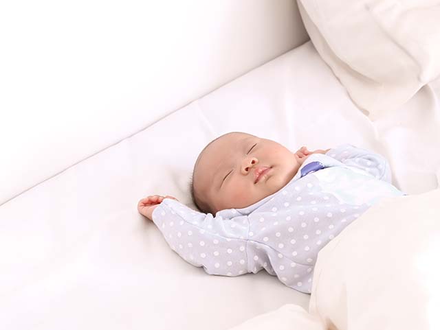 Baby sleeping with arms in the air, sleep training methods