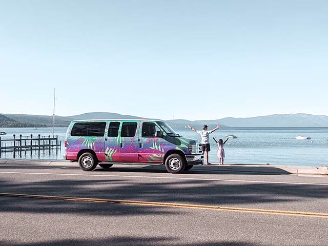 Campervan around Lake Tahoe with family, roadside scenery, family admiring the beautiful lake view.