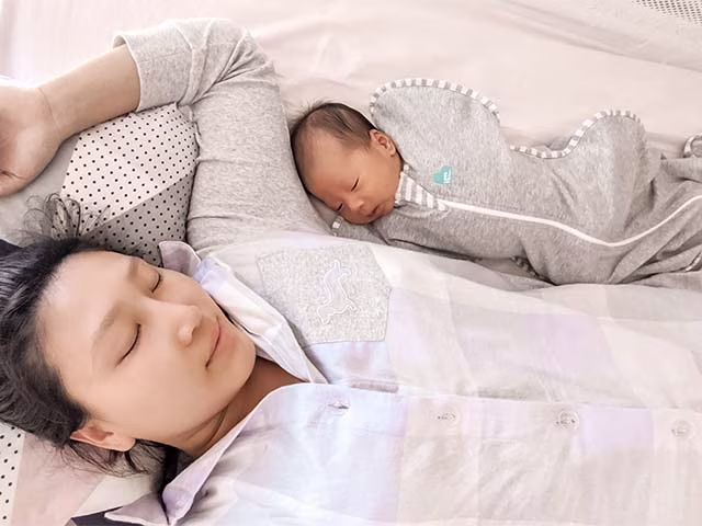 Mother baby co sleeping on bed