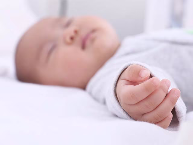 Baby sleeping with cute little infant hand