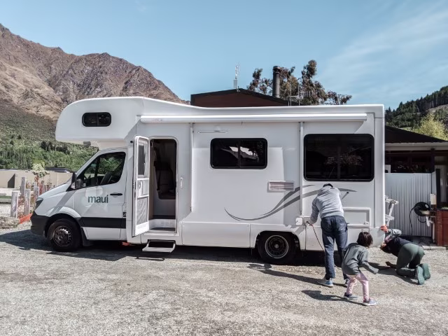 Family on a road trip in Maui campervan around New Zealand replenishing water