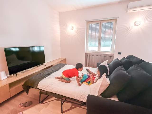 Kids on sofa bed at last minute hotel booking holiday home