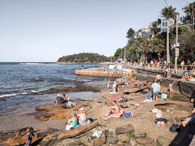 Scenic walk to Shelly Beach people sunbathing on the rocks Manly Travel Guide Sydney