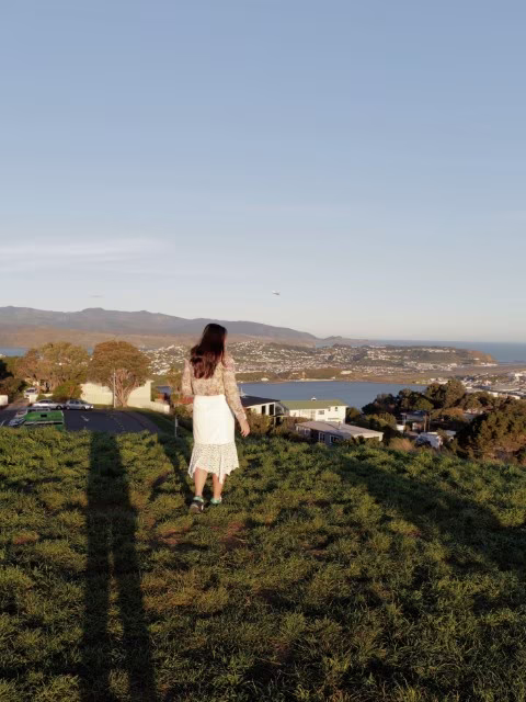 Woman looking over at the sweeping panoramic view of Wellington city at wellington mount victoria lookout
